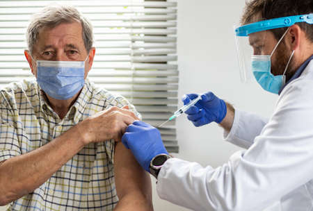 senior man getting vaccineの写真素材