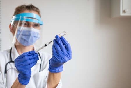 doctor preparing to give vaccine