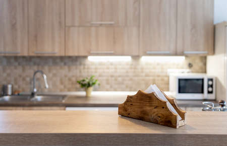 blurred kitchen interior and wooden desk space home background