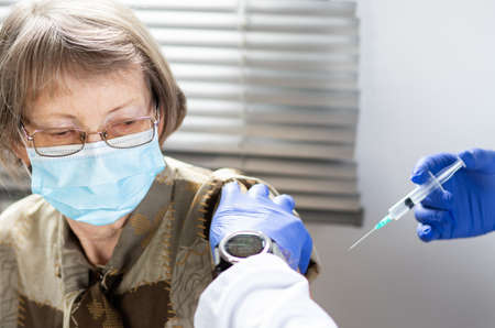 elderly woman getting vaccine