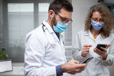 two doctors discussing diagnostics team workの写真素材