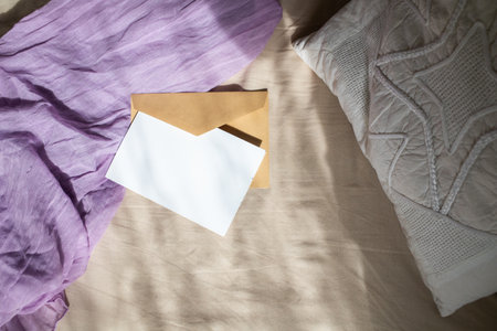 blank greeting card  invitation mockup with craft paper envelope  feminine still life compositionの写真素材