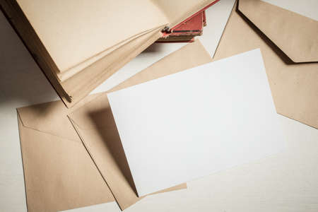 blank greeting card  invitation mockup with craft paper envelope  feminine still life compositionの写真素材