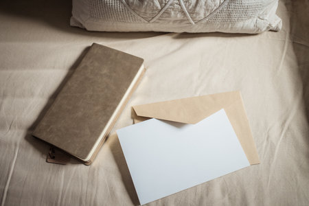 blank greeting card  invitation mockup with craft paper envelope  feminine still life compositionの写真素材