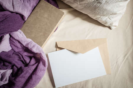 blank greeting card  invitation mockup with craft paper envelope  feminine still life compositionの写真素材