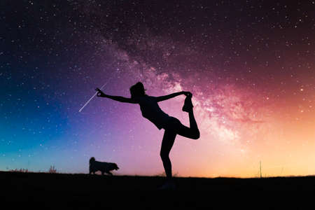 woman doing yoga under night sky with stars spirituality