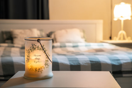 cozy bedroom detail focus on burning candle