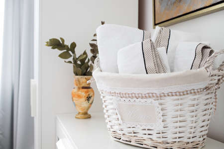 clean towels in a basket in hotel roomの写真素材