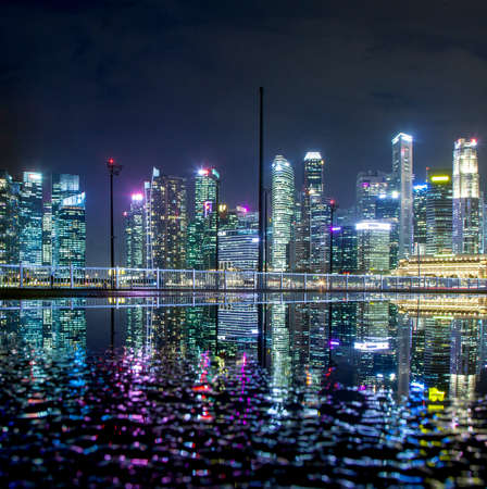 SINGAPORE, SINGAPORE - MARCH 2019: Skyline of Singapore Marina Bay at night with Marina Bay sands, Art Science museum , skyscrapers and tourist boatsのeditorial素材