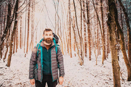 handsome man trekking in beautiful winter landscape social distancingの写真素材