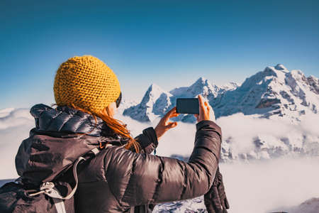 woman traveler in Swiss alps Jungfrau region taking picturesの写真素材