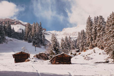 cottage covered with snow in the mountains
