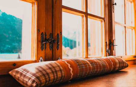 rustic window and snowy mountains in background
