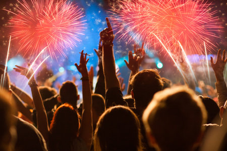 crowd celebrating New Year's Eve watching fireworksの写真素材