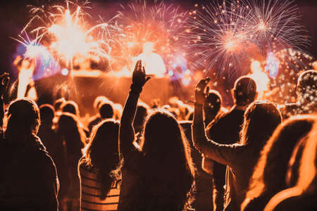 cheering crowd watching fireworks at New Year - holiday celebration backgroundの写真素材