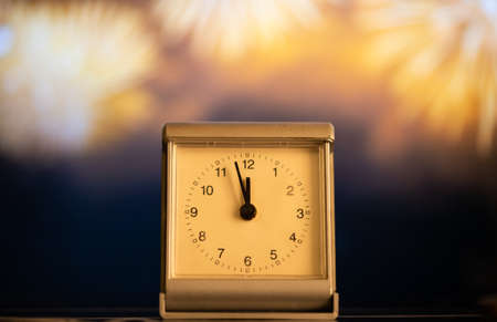 clock at midnight and fireworks  New Year's eve celebration