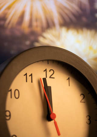 clock at midnight and fireworks  New Year's eve celebration