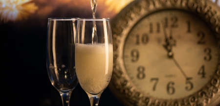 champagne glasses, clock at midnight and fireworks  New Yearの写真素材