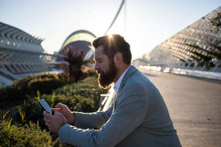 handsome businessman with phone in the cityの写真素材