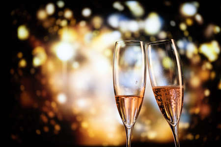 two champagne glasses and festive light happy New Yearの写真素材