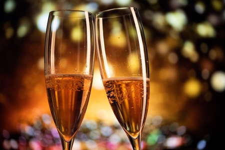 two champagne glasses and festive light happy New Yearの写真素材
