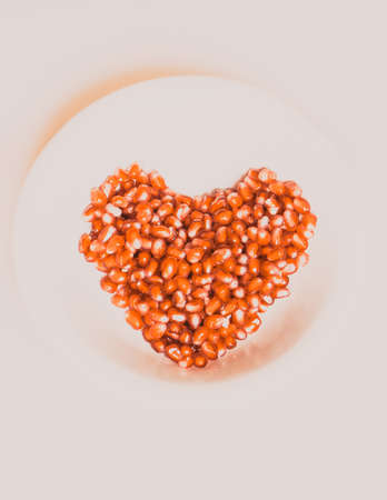 pomegranate seeds in a hearth shapeの写真素材