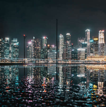 SINGAPORE, SINGAPORE - MARCH 2019: Skyline of Singapore Marina Bay at night with Marina Bay sands, Art Science museum , skyscrapers and tourist boatsのeditorial素材
