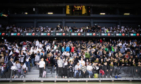 blurred background of supporters at sports event crowd of people in a basketball courtの写真素材