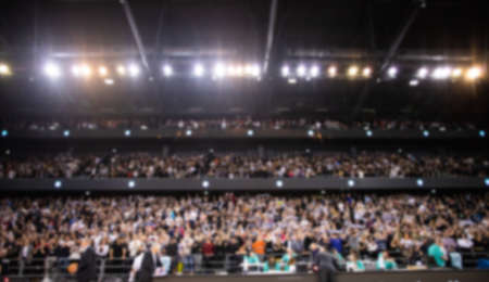 blurred background of supporters at sports event crowd of people in a basketball courtの写真素材