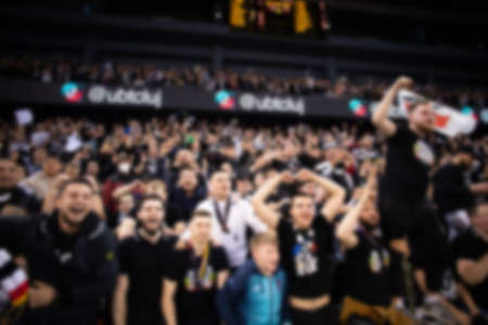 blurred background of supporters at sports event crowd of people in a basketball courtの写真素材
