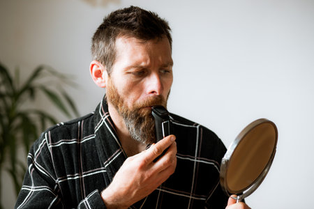 handsome man shaving his beardの写真素材