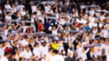 blurred supporters crowd in a basketball court during gameの写真素材