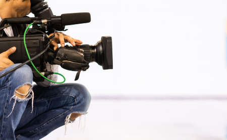 cameraman filming an event focus on cameraの写真素材