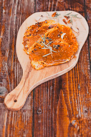 raw meat with herbs and rosemary ready for barbecueの写真素材