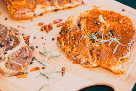 raw meat with herbs and rosemary ready for barbecueの写真素材