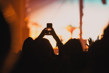 cheering crowd with raised hands at concert - music festivalの写真素材