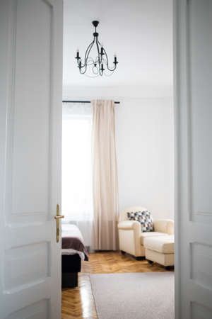 vintage white door opening into bedroomの写真素材