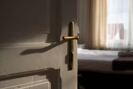 vintage white door opening into bedroomの写真素材