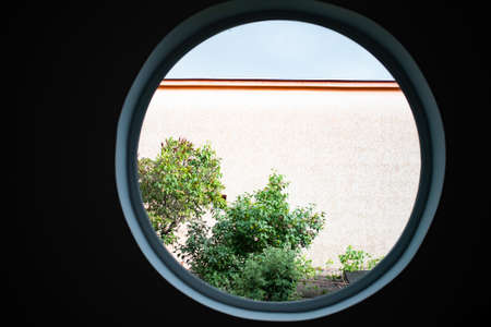 round window tree and houseの写真素材