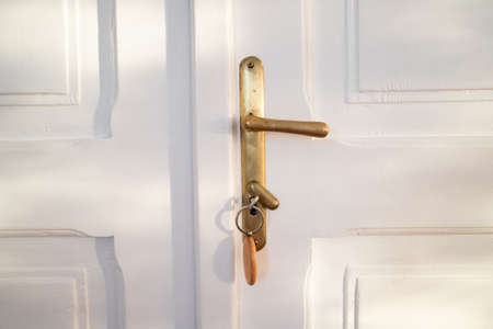 key opening white door to a modern homeの写真素材