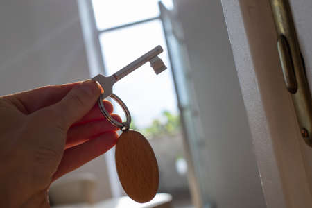 key opening white door to a modern homeの写真素材
