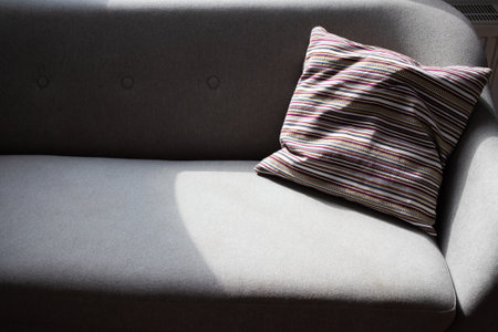 grey sofa detail in bright living room