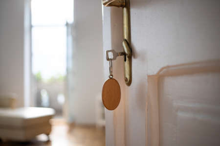 key opening white door to a modern homeの写真素材