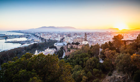 view over Malaga at sunset travel bannerの写真素材