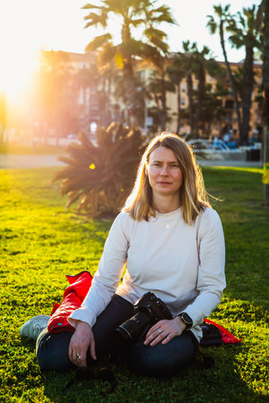 happy beautiful woman enjoying sunset in the parkの写真素材