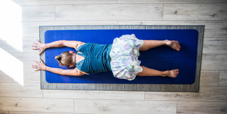 top view of woman doing yoga on mat