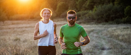 fit couple running with dogの写真素材
