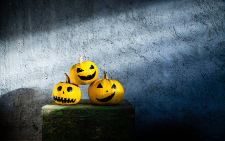 scary funny Halloween pumpkins on wooden tableの写真素材