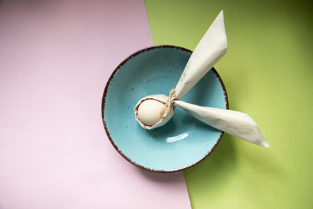 egg wrapped in easter bunny shaped napkinの写真素材