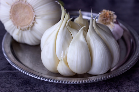 Fresh garlic on a dark background. Organic nutrition.